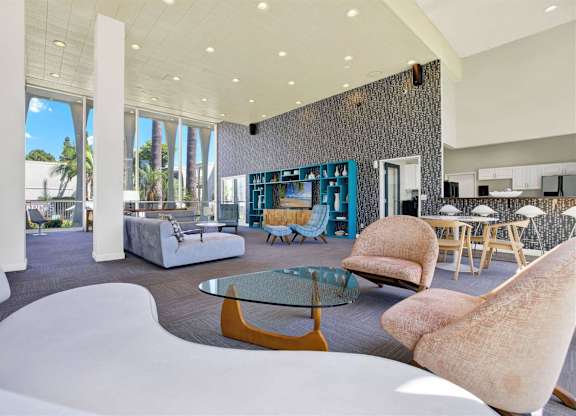 Clubhouse lounge with dining area and textured accent wall at Parc @ 5 Apartments, California, 90240