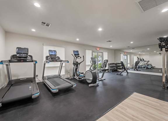 the gym is equipped with treadmills and other fitness equipment at Monterra Ridge Apartments, California,91351