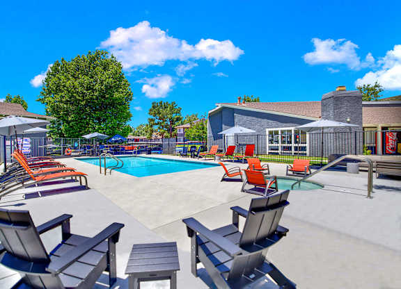 our apartments have a large pool with chairs and tables at Monterra Ridge Apartments,California