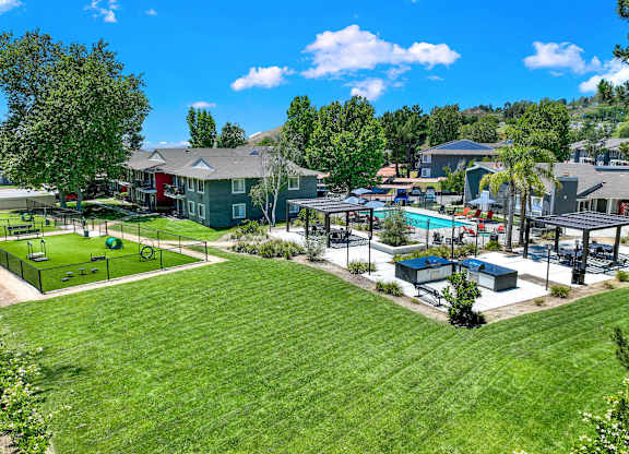 a park with a playground and a pool in a community at Monterra Ridge Apartments, Canyon Country, California