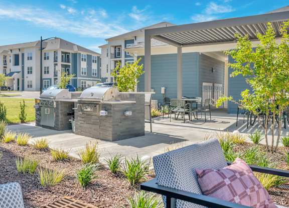 A sunny day at a residential complex with a picnic table and chairs.