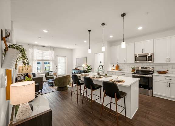 A modern kitchen with white cabinets and a large island.