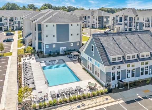 A large building with a pool in front of it.