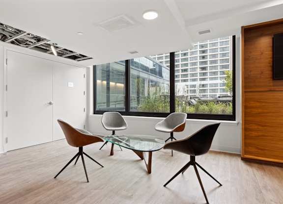 A modern room with a glass table and chairs.