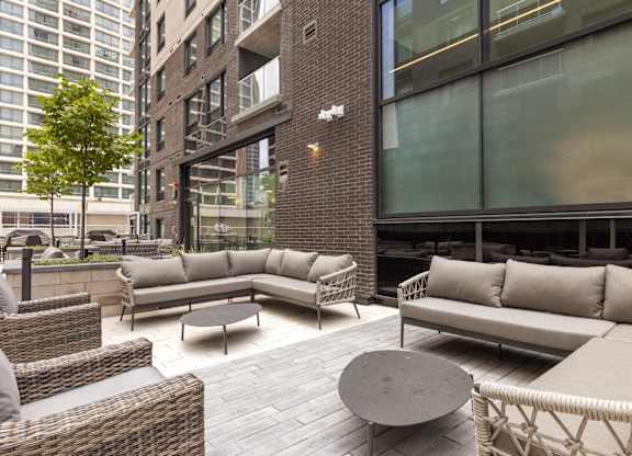 A patio with a couch, chairs and a table.