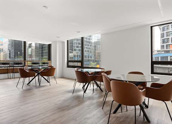 A conference room with brown chairs and a long table.