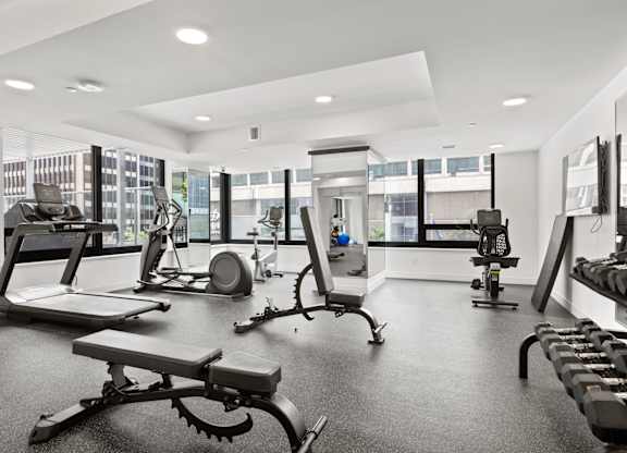 A spacious gym with a variety of equipment including treadmills, weights, and exercise machines.