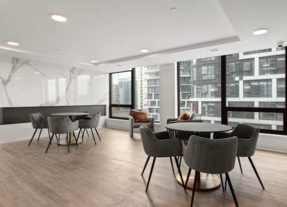 A modern dining room with a large table and chairs.