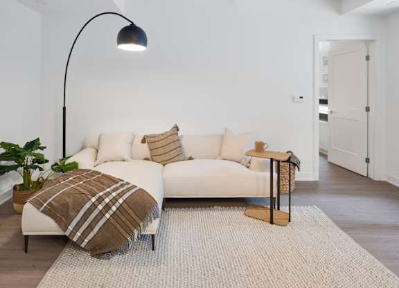 a living room with a couch and a lamp