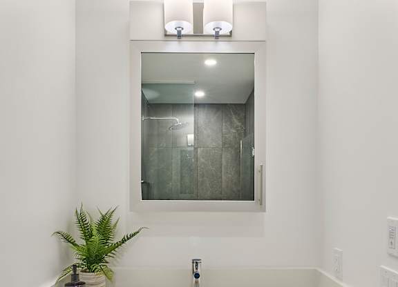 a white bathroom with a sink and a mirror