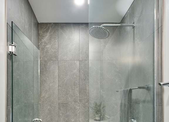a shower with a glass door in a bathroom