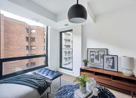 a bedroom with a bed and a large window