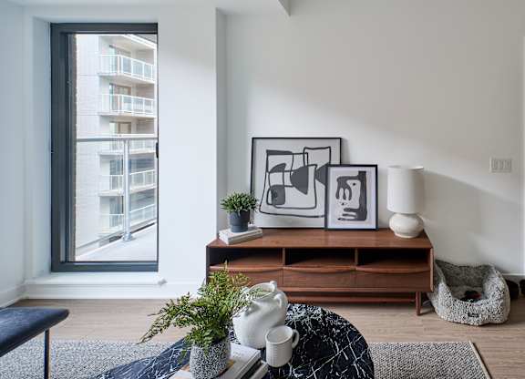 a living room with a couch and a table and a window