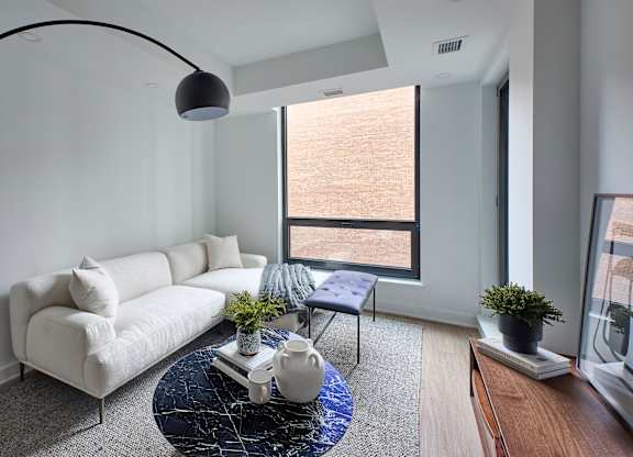 a living room with a white couch and a blue table