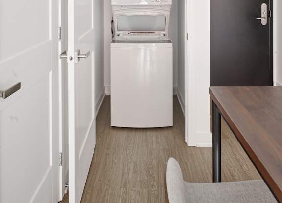 a small room with a refrigerator and a washing machine in it