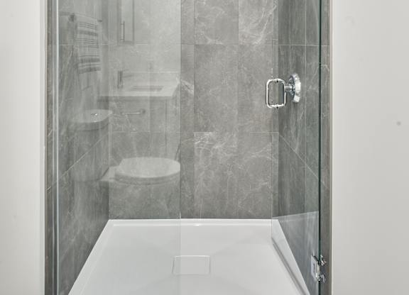 a shower with a glass door in a bathroom