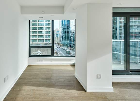 a living room with a large window and a view of the city