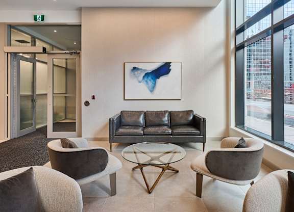a living room with couches and chairs and a table