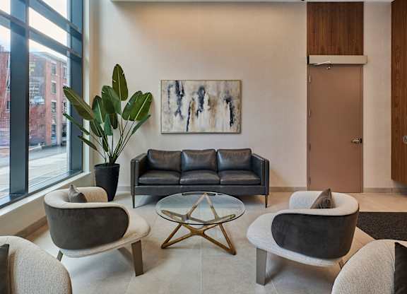a living room with a couch and chairs and a table