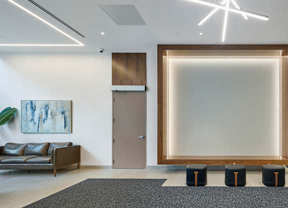 a large empty frame in a room with a couch and elevators