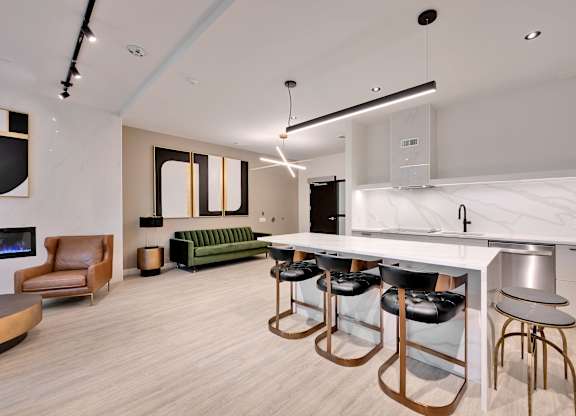 A modern kitchen with a bar area and seating.