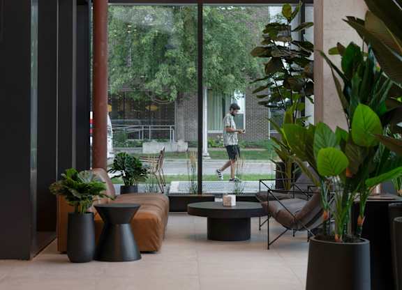 A large window with a view of a building and trees.