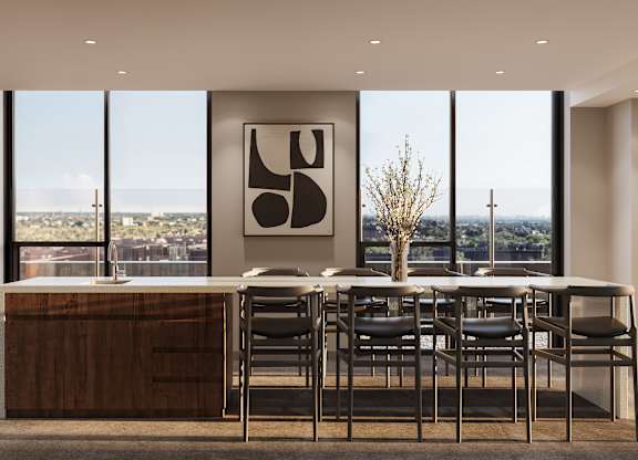 A modern kitchen with a dining table and chairs.