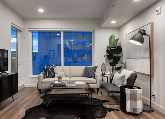 A modern living room with a black and white color scheme.