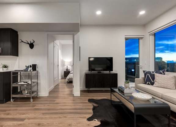 A modern living room with a large window overlooking the city.