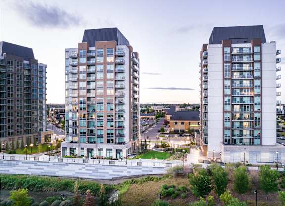 Three modern apartment buildings are shown in the image.