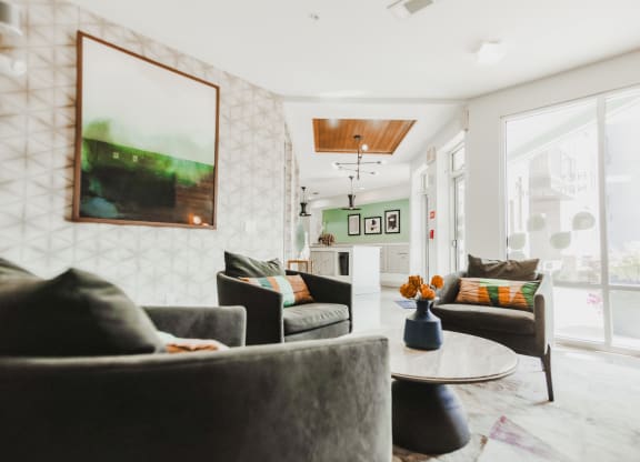 a living room with couches and chairs and a table at Canalside, Augusta, GA