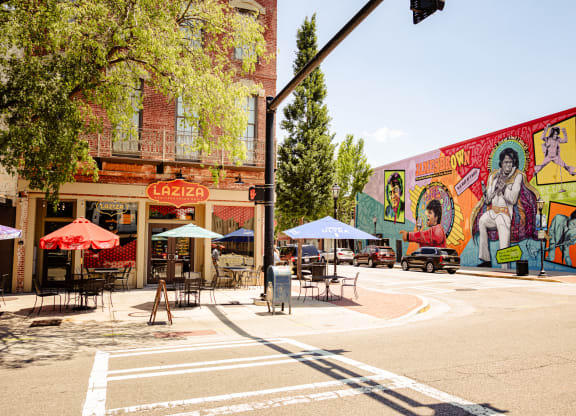 a street corner with a mural on the side of a building at Canalside, Augusta, GA