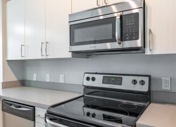 Kitchen with cabinets and white interior as well as appliancesat Canalside, Augusta