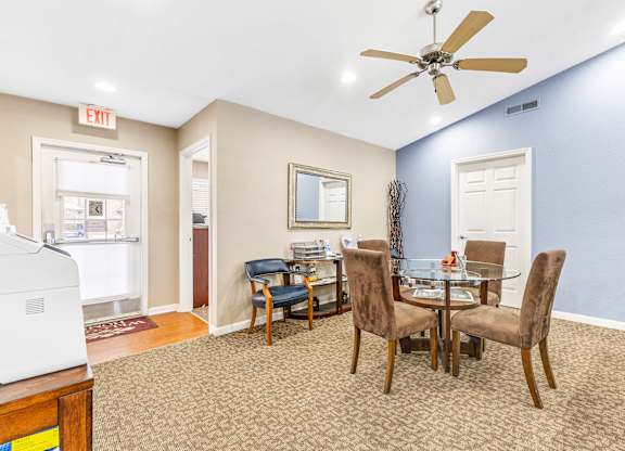 Dining area with glass table and brown chairs at Northampton Village Apartments, Indianapolis, 46226