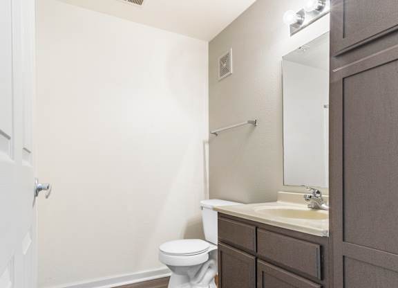 Bathroom with wood style flooring and dark vanity at Northampton Village Apartments, Indianapolis, Indiana
