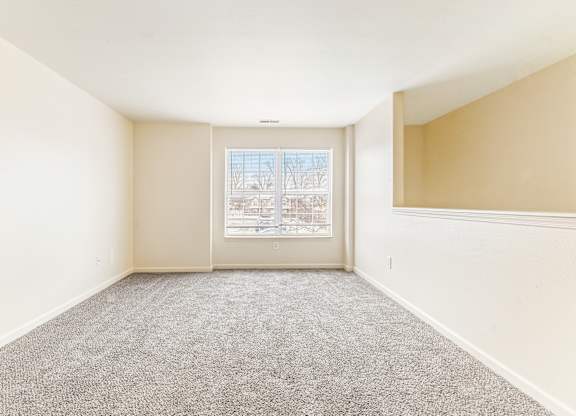 Spacious living room with carpet and window at Northampton Village Apartments, Indiana, 46226