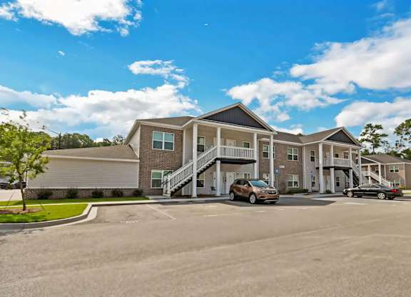 A large building with a parking lot in front of it.