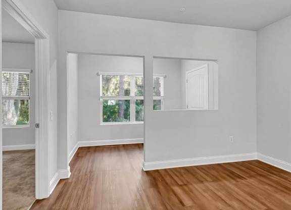 A room with wooden floors and white walls.