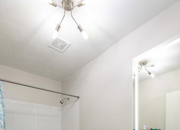 A white toilet sits in a bathroom next to a sink.