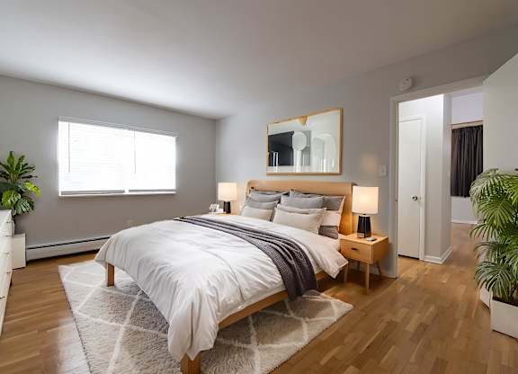 A bedroom with a large bed and a mirror above it.