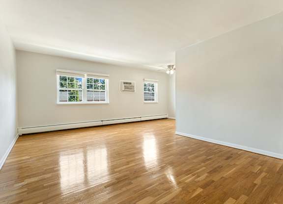 A room with wooden floors and white walls.