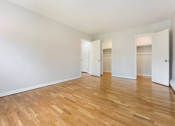 A room with wooden floors and white walls.