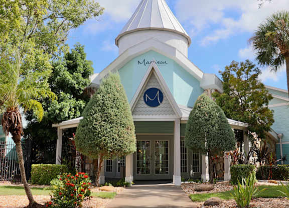 A white building with a blue roof and a sign that says "Marson".