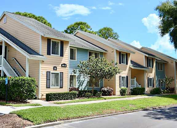 A row of houses with a clear blue sky above them.