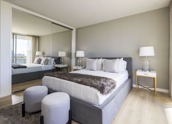 a bedroom with a bed and a mirror