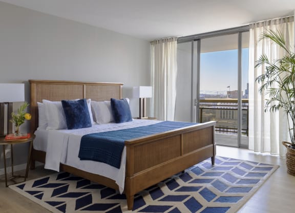 a bedroom with a bed and a view of the city