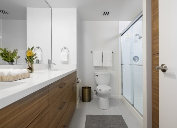 a bathroom with a toilet and a sink and a shower