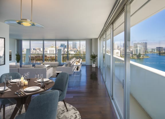 a rendering of a living room with tables and chairs and a balcony with a view