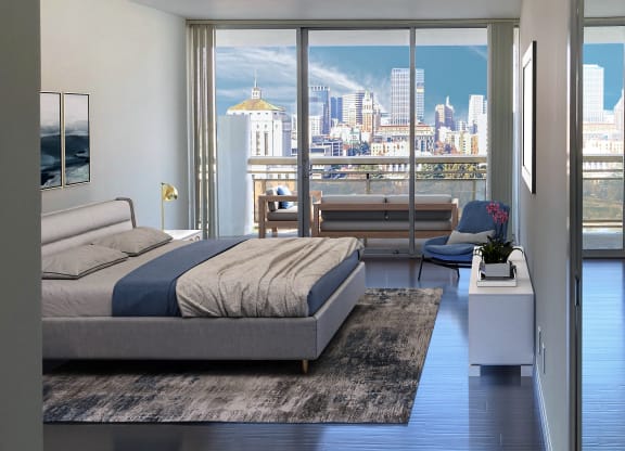 a bedroom with a bed and a view of the city