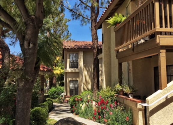 a sidewalk in front of some buildings and trees at Victoria Springs, Riverside, CA